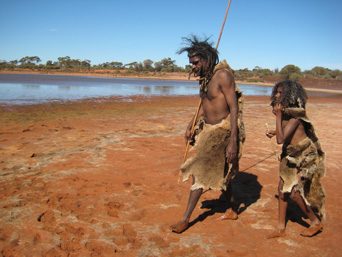 Two Native People Walking on Lake Bed