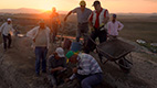 image of group of archaeologists at an excavation site