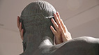 hands touching statues head