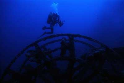 Diver Inspecting Remains of Ship